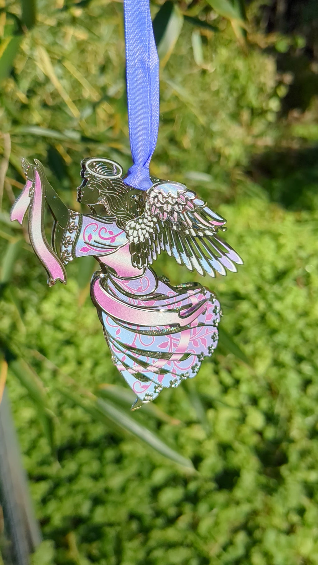 Video of metal angel ornament with pink and blue swirl pattern dress
