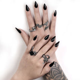 Pewter ring with black rose, shown on hands with other rings