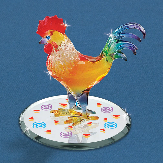 Colorful glass rooster figurine on a decorative base against a blue background