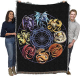 Tapestry blanket with eight dragons in a wheel formation, different colors to represent different points in the year. Held by two adults to show large size