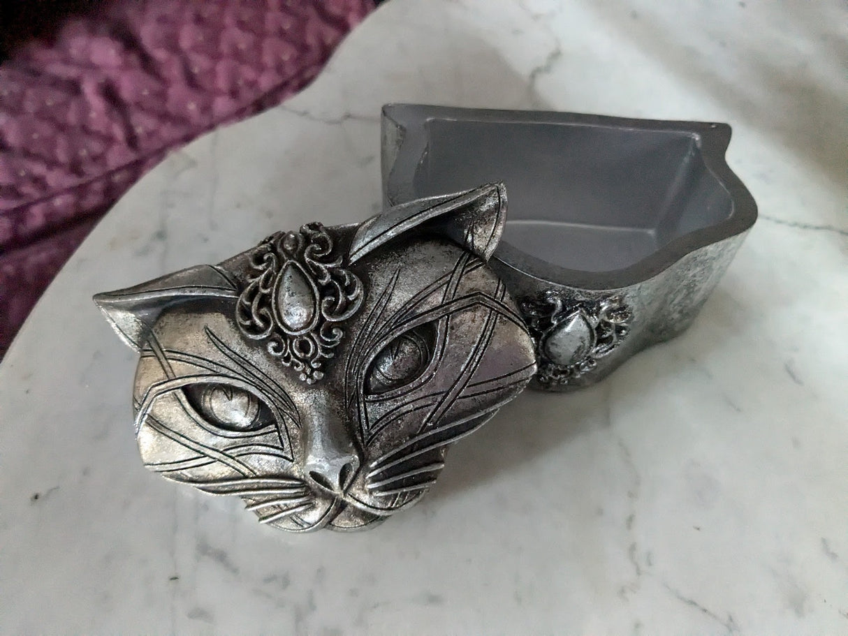 Silver colored cat trinket box with jewel on forehead, shown with lid open and off to the side