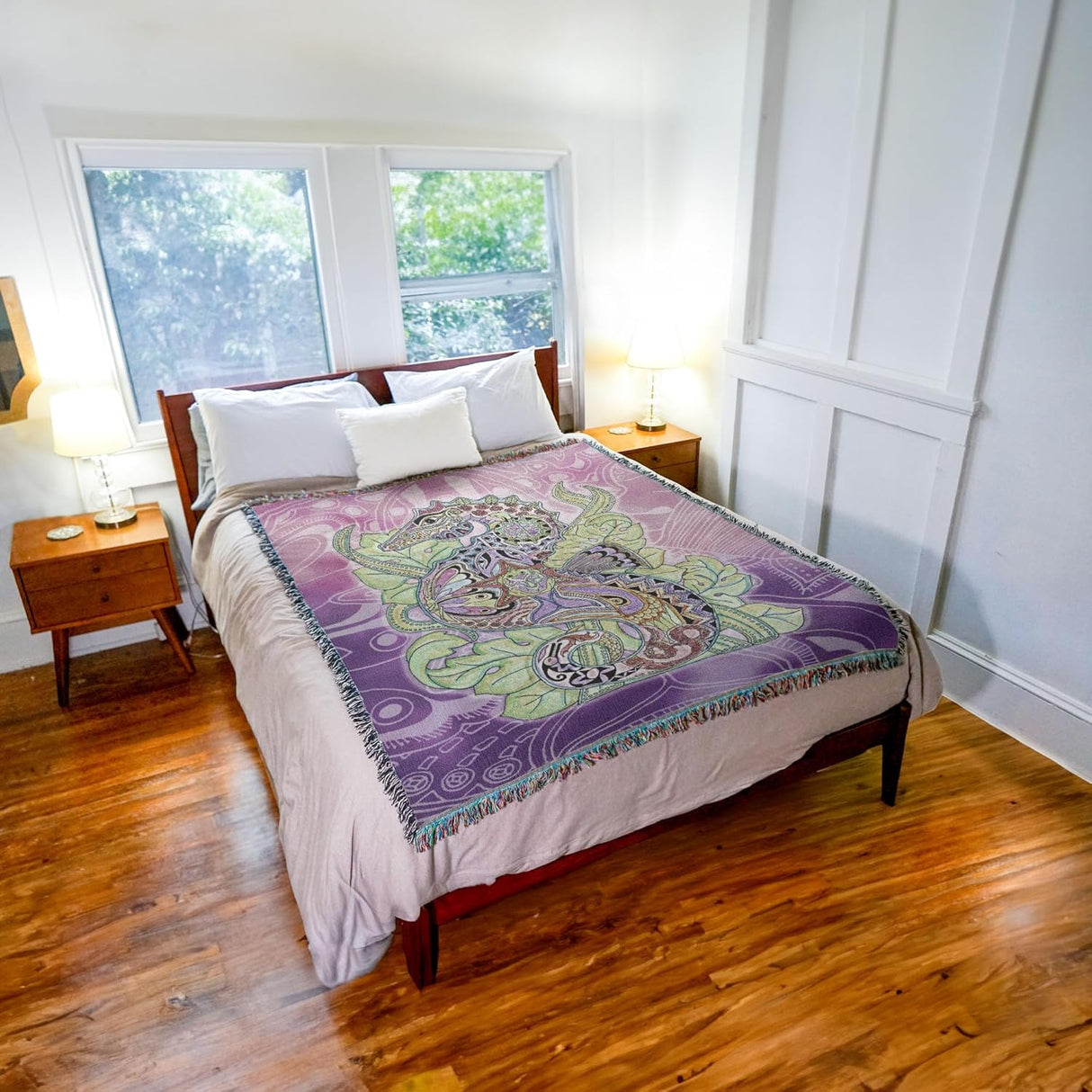 Bedroom with a bed featuring a colorful seahorse-patterned blanket.