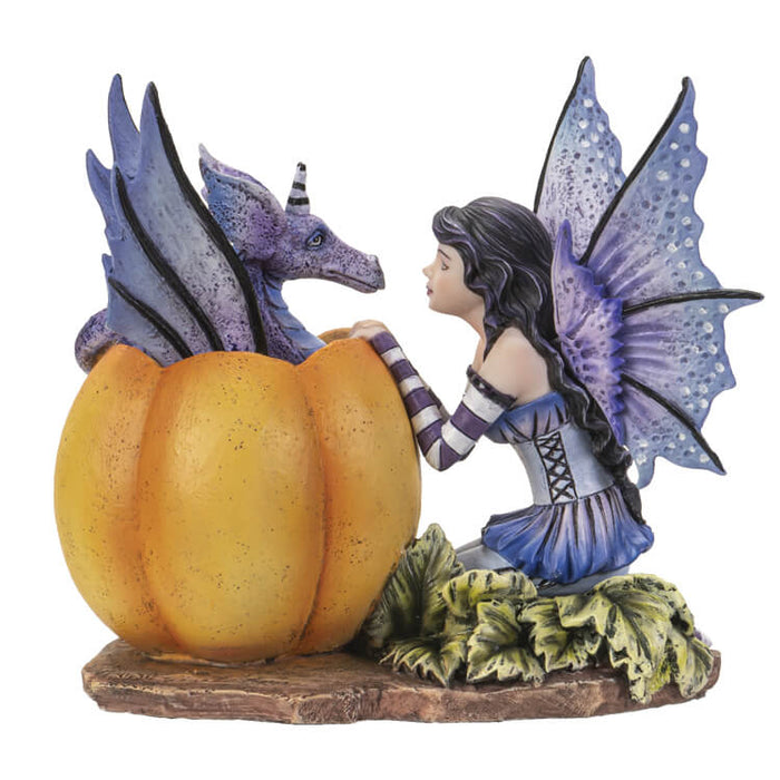 Dark haired fairy with purple wings and dress and striped sleeves & Stockings kneels in front of a pumpkin with a periwinkle dragon popping out