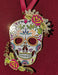 Colorful sugar skull skeleton ornament with red flowers and swirl designs and leaves