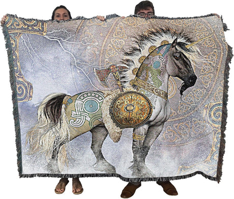 Blanket with a battle unicorn design held by two people against a white background