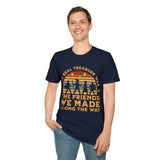 Person wearing navy blue t-shirt with vintage-style rainbow & adventurers graphic and text reading "The real treasure was the friends we made along the way"