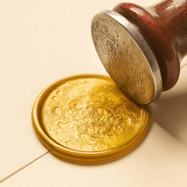 Full moon wax seal coin with an example seal in gold wax