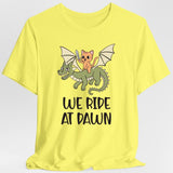 Yellow t-shirt with a cat riding a dragon graphic and 'We Ride at Dawn' text