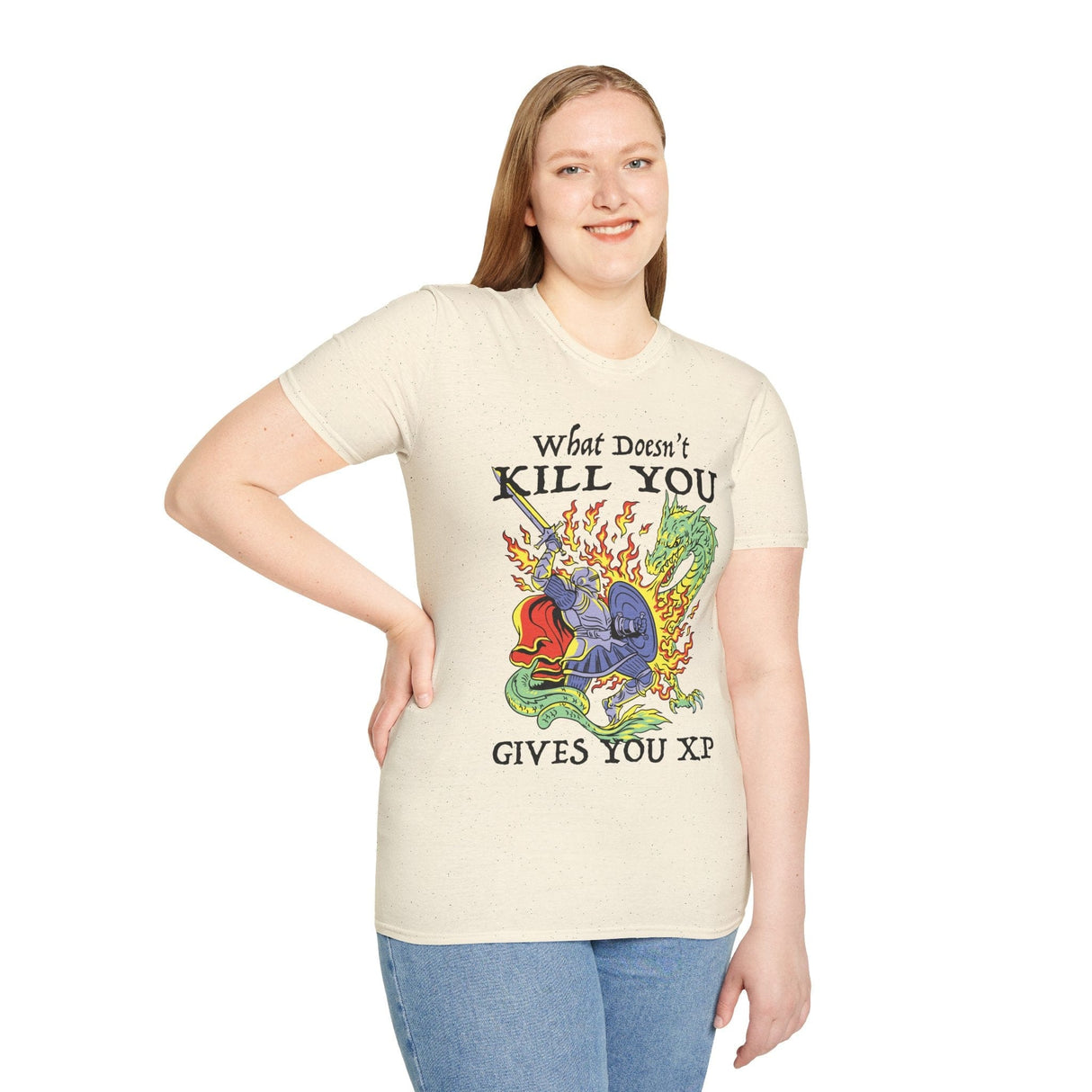 Lady wearing off white  t-shirt with a graphic design of knight fighting a dragon and text reading "What Doesn't Kill You Gives You XP"