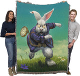 Tapestry blanket featuring the White Rabbit with pocketwatch from Alice in Wonderland, held by two adults