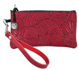 Ginkgo leaves on a leather wristlet pouch, shown in red