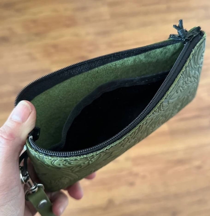 Wristlet pouch, shown open with pocket divider inside