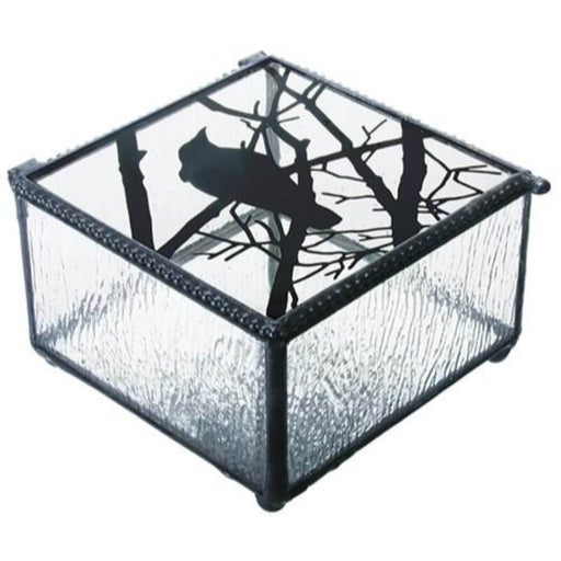 Clear glass box with black raven on branches silhouette on lid