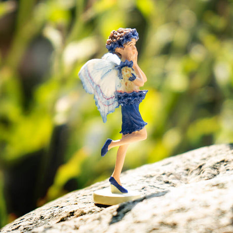 Cicely Mary Barker flower fairy figurine dressed in blue with butterfly wings.