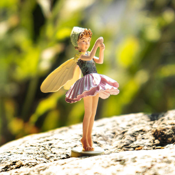 Cicely Mary Barker Flower Fairy Figurine dressed in a poppy blossom of pink and green with pale yellow wings