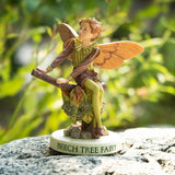 Flower Fairy figurine - Beech Tree Fairy written on base, pixie boy in pale green and brown/tan with short hair sitting on a branch