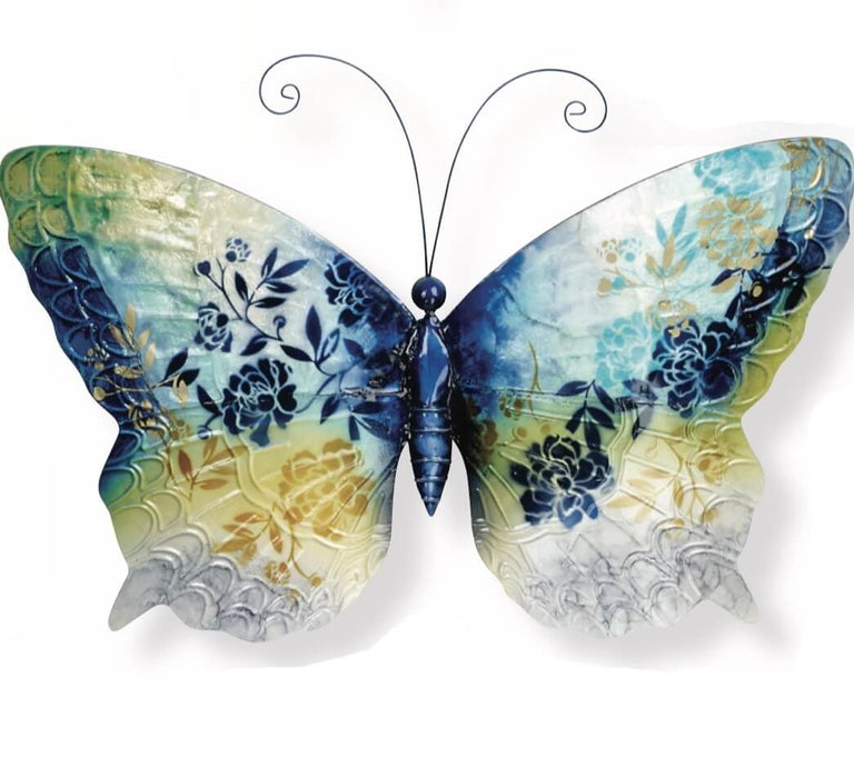 he lovely butterfly is made of iridescent capiz shell. Across its wings are floral designs in shades of blue, gold, green and white, like a meadow under sunny skies. 