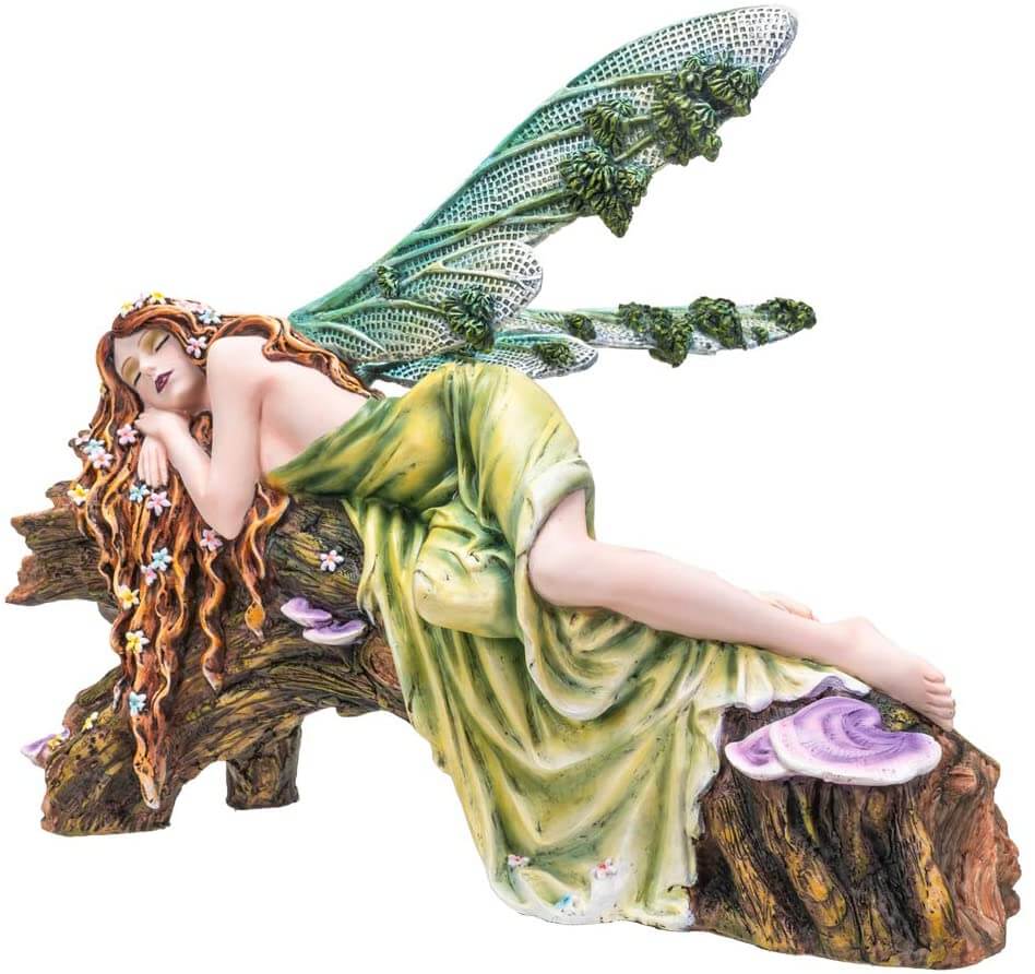 The statue features a lovely pixie sleeping on a forest log. The fae lady has a green dress and leafy emerald dragonfly wings to match. Her red-brown hair is adorned with colorful flower blossoms, and purple mushrooms sprout from the wood she slumbers on.