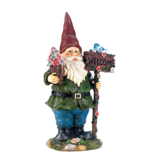 Gnome holding flower topped birdhouse and a welcome sign, upon which sits a bluebird