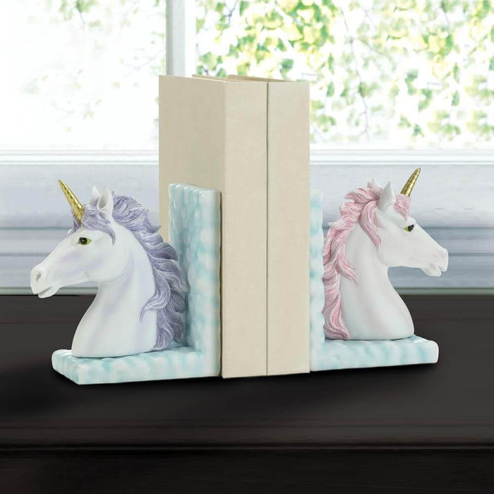 Purple and pink unicorn bookends displayed on a windowsill, holding two books.