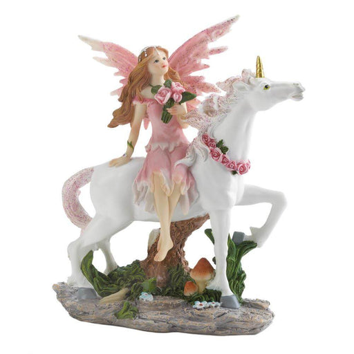 Fairy with pink wings and dress holding roses rides a white unicorn with golden horn and glittery mane. They ride through a landscape of shrubs and mushrooms
