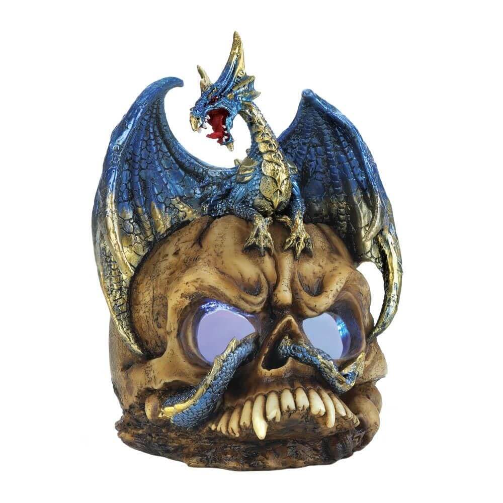 Blue dragon sits atop a skull who's eye sockets glow with eerie light