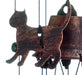 Closeup of one of the metal cats on the wind chime