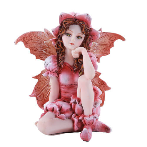  The little figurine is ideal for a fairy garden. She wears a pink dress and has peach wings to match, and a flower hat! She gazes out serenely.