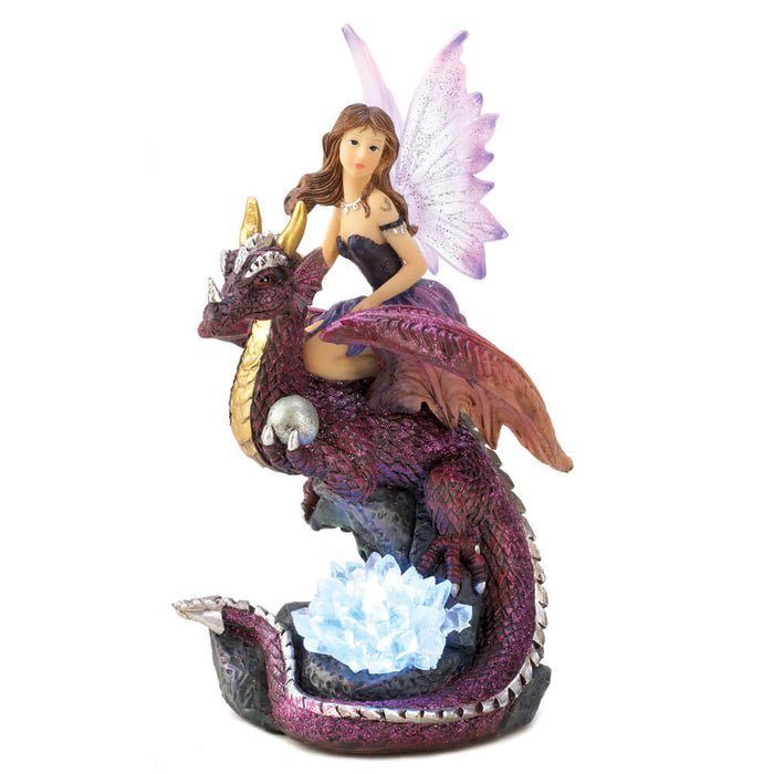 Brunette fairy in black dress with pink sparkly wings rides on a purple-red dragon with gold accents. Crystals on the base light up via LED