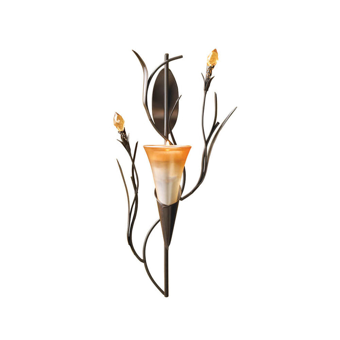 Candle holder mimicking a golden lily with faceted flower buds to either side and one candle cup flower at the center