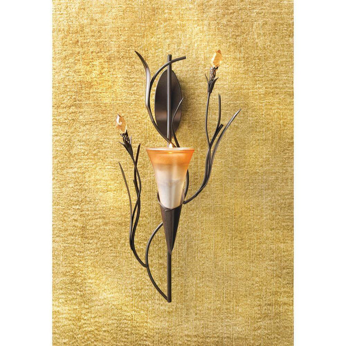 Single golden lily flower candle holder displayed against a tan backdrop