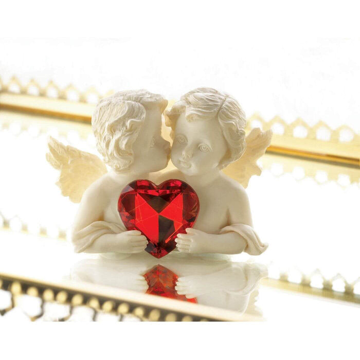 Cherub pair with crystal heart shown displayed on a mirror