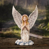 Praying angel figurine shown with a forest background