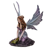 Leaf Fairy Figurine shown from the side. Her hair is in a bun with flowers