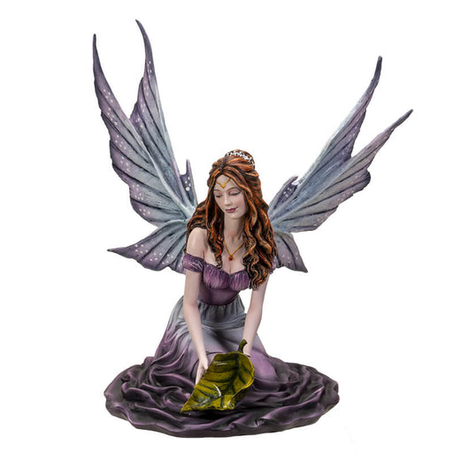 Figurine of a Fairy with purple wings and dress and red-brown hair holding a green leaf