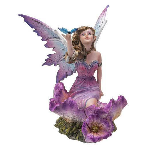 Fairy figurine; she has brown hair and a purple dress surrounded by matching flowers. She looks up at the blue butterfly perched on her outstretched hand.