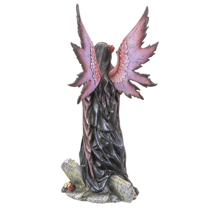 Gothic fairy and tombstones shown from behind with red and pink-purple wings