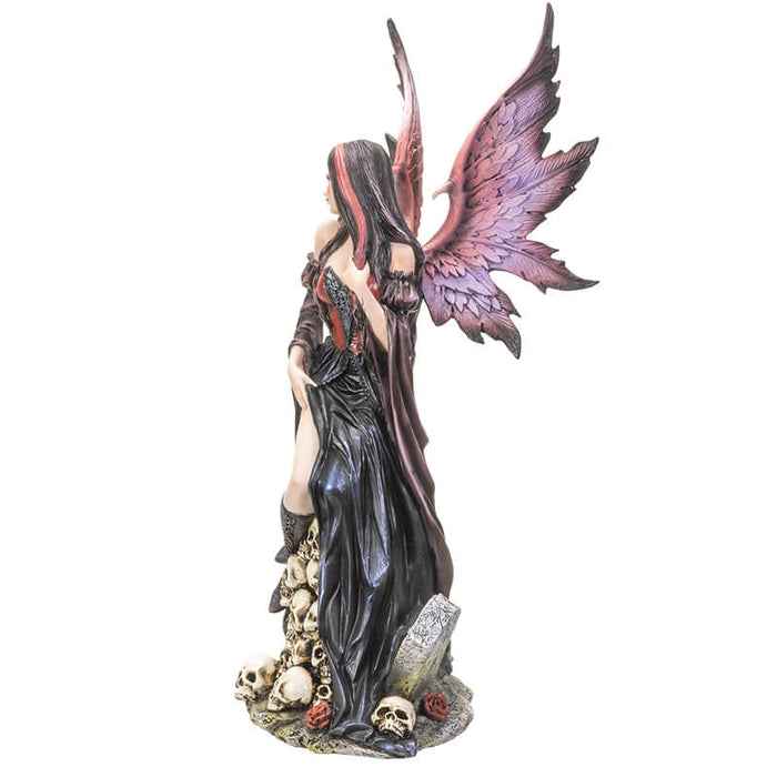 Side view of Gothic fairy with skulls and gravestone