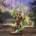 Satyr wizard with green magic flowing all around him. He has a set of panpipes and wears a loincloth over his faun goat legs, and horns grow from his head. Shown in a forest backdrop