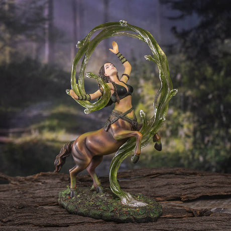 Centaur sorceress rears up above the forest floor, commanding swirling green earth magic that encircles her. Figurine based upon the art of Anne Stokes. Shown in a forest backdrop setting