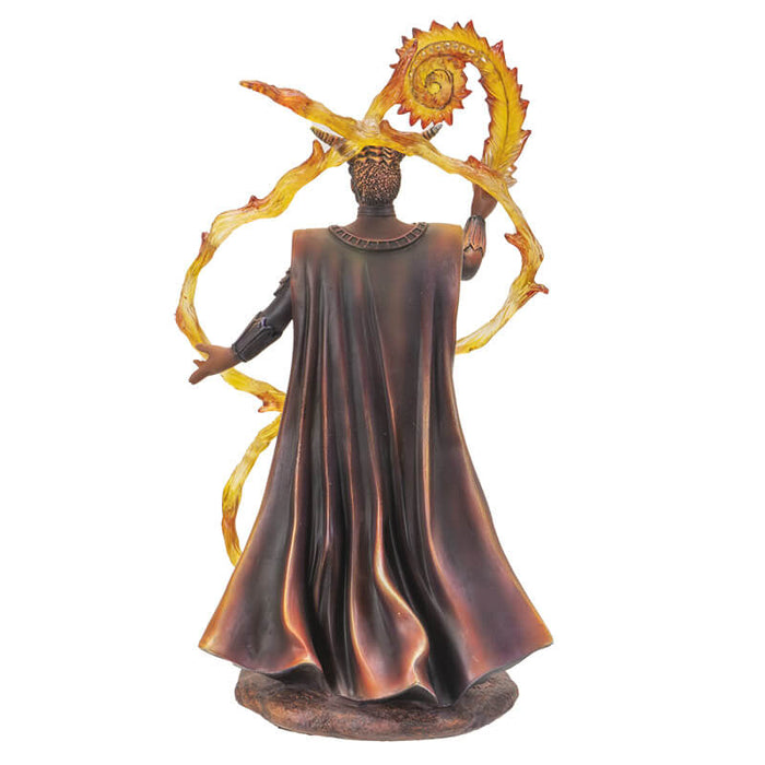 Fire wizard statue based on Anne Stokes artwork. Clad in armor and with horns. Bonfire in front of him and translucent fire swirling up around him in curving patterns. Shown from the back - cloak has flowing, life-life ripples.