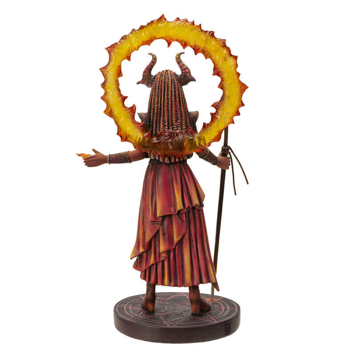 Fire Sorceress figurinec clad in red, orange and black clothes, holding a staff with a ring of fire around her horned head. Stands on black decorated base. Shown from the back
