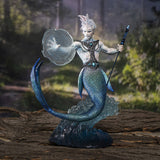 Merman with water magic and a trident. He has iridescent scales and a jeweled breastplate, and is supported on a blue transparent wave. Shown against a forest backdrop