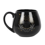 Fortune Teller Color Change mug. Black base with hands and a crystal ball. The words "The future is in your hands" are revealed when a hot beverage is poured in