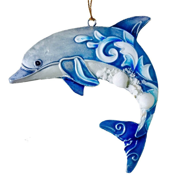 Dolphine ornament in shades of blue and white with wave swirl designs and seashell accents