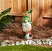 Solar gnome holding a clear orb, displayed in a sunny garden