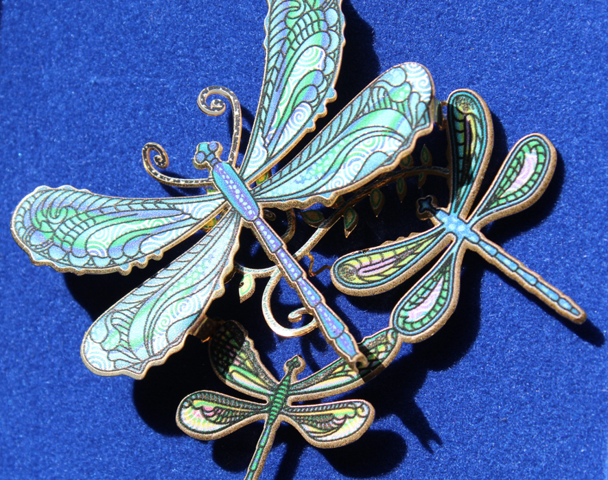 Closeup of Dragonfly Collage ornament showing dragonflies of differing sizes done in shades of blue and green