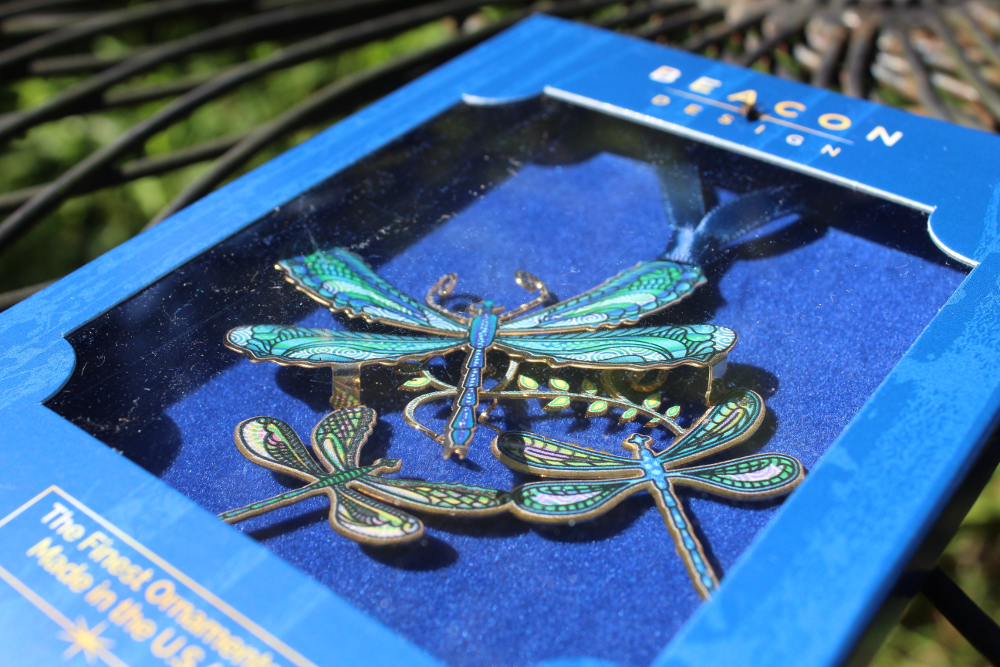 Dragonfly Collage ornament shown in blue window giftbox