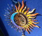 Side view of sun and moon ornament showing 3D layered metal