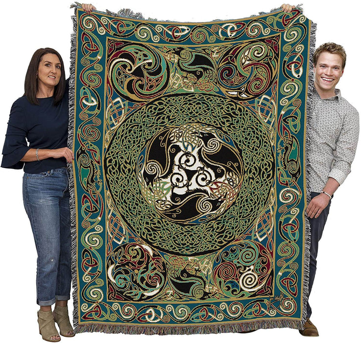 Raven tapestry blanket held up by two adults to show large size